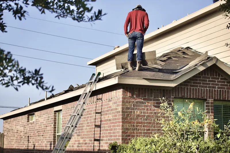 Professional roofer working on a residential roof in Port Providence